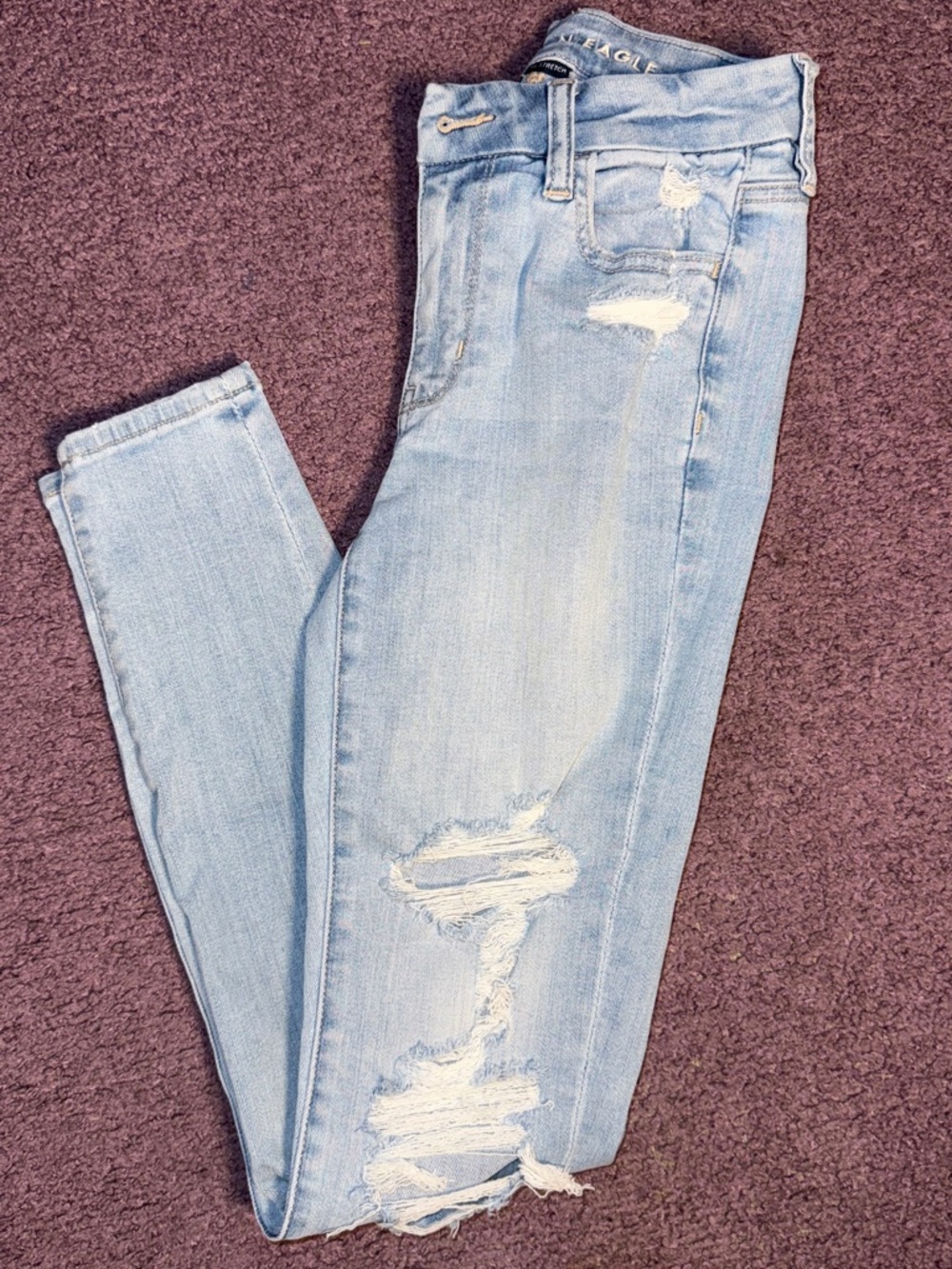 American Eagle Next Level Stretch Light Blue Distressed Skinny Jeans